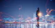 Working till late night. Young elegant businesswoman against night city background创意图片素材 - Ingram