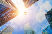Airplane flying over modern business skyscrapers. Transport, tra创意图片素材 - 500px Core RF