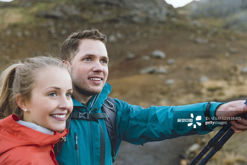 Smiling hiking couple on volcanic landscape
