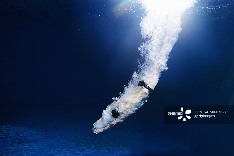 man diving into water