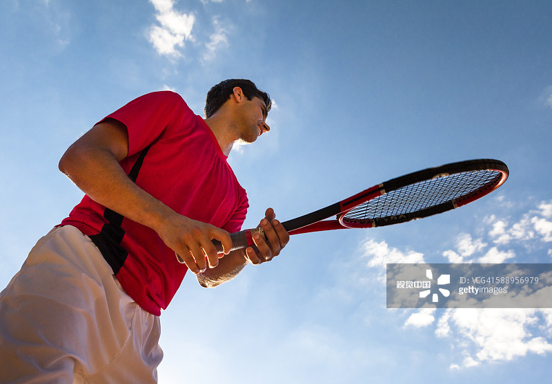 Male tennis player in ready position
