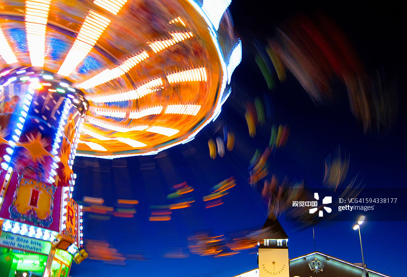 Blurred view of carnival ride at night Blurred view of carnival ride at night创意图片素材 - Photographer's Choice