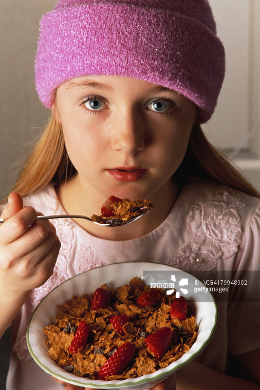 Girl Eating Cereal with Strawberries