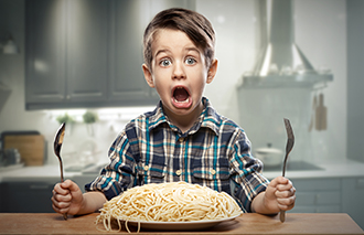 Startled yound boy with noodles 500px图片素材