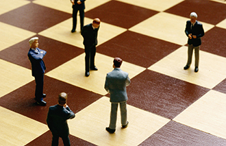 Businessmen figures on a chess board - strategy, competition, decision making concept corbis图片素材