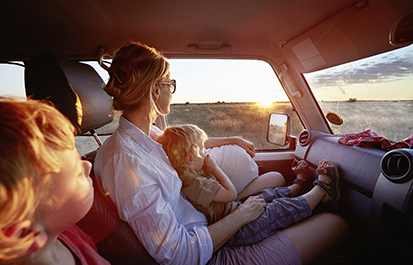 Family in a Toyota Landcruiser watching wildlife in the Nxai Pan National Park at sunset corbis圖片素材