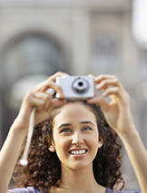 Young Woman Taking Photograph corbis圖片素材