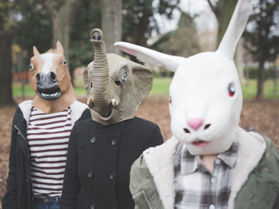 Three sisters wearing animal masks posing in park gettyimages图片素材