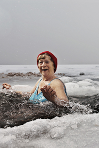 Elderly woman bathing in the frozen sea. gettyimages图片素材